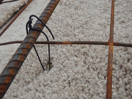 Wire-tying rebar to earthlodge.