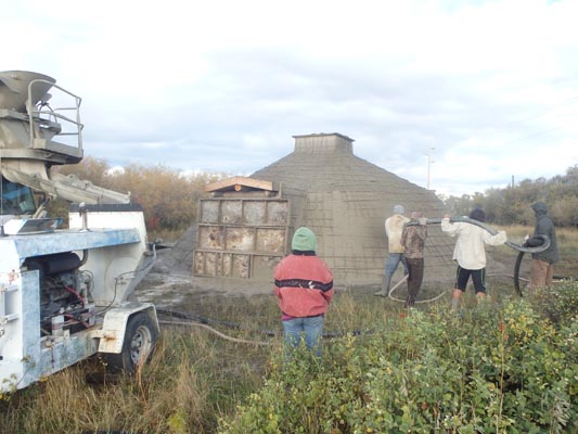 Covering the earthlodge with shotcrete.