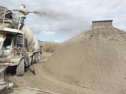 Spraying shotcrete from the top of the cement truck.