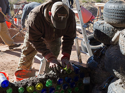 Mortaring a bottle wall.