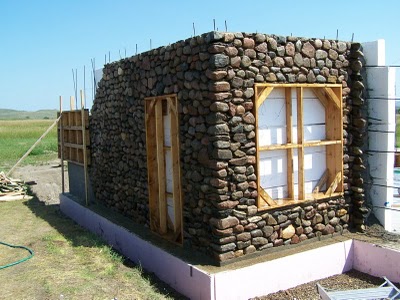 Slipform stone wall with framed window openings.