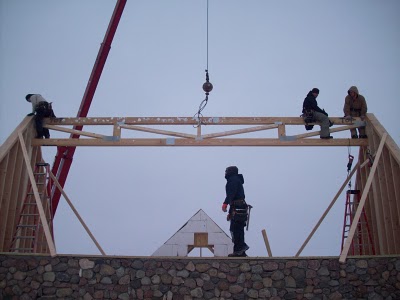 Roof ridge truss supported by gable ends.