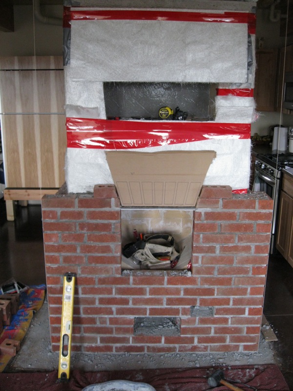 Adding brick facing to a Finnish masonry stove.