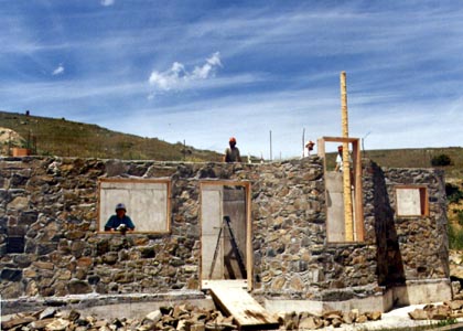 Slipform stone first floor with lift pole.