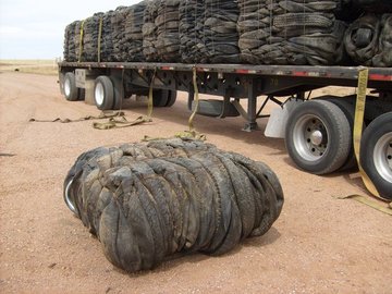 A bale of tires and a truckload of tire bales.