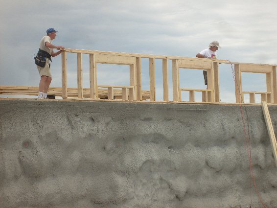 Framing the back wall, on top of the tire bales.