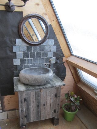 Installing a stone bowl sink in the master bathroom.