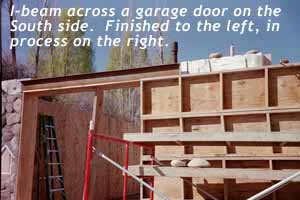 Garage door I-Beam straddling stone walls.