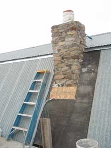 Stone chimney around flue.