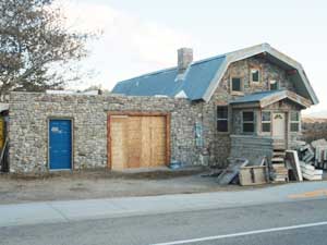 Stone front of garage revealed.