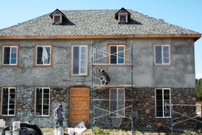 Plastering over strawbales.