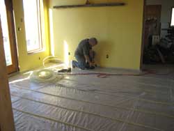 Installing radiant tubing for a terra tile floor.